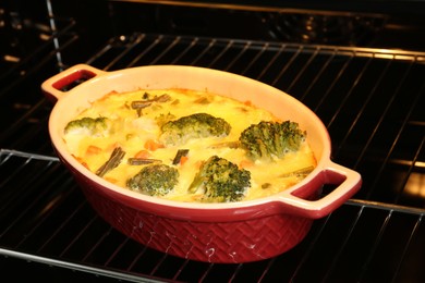 Photo of Delicious vegetable casserole in oven, closeup view