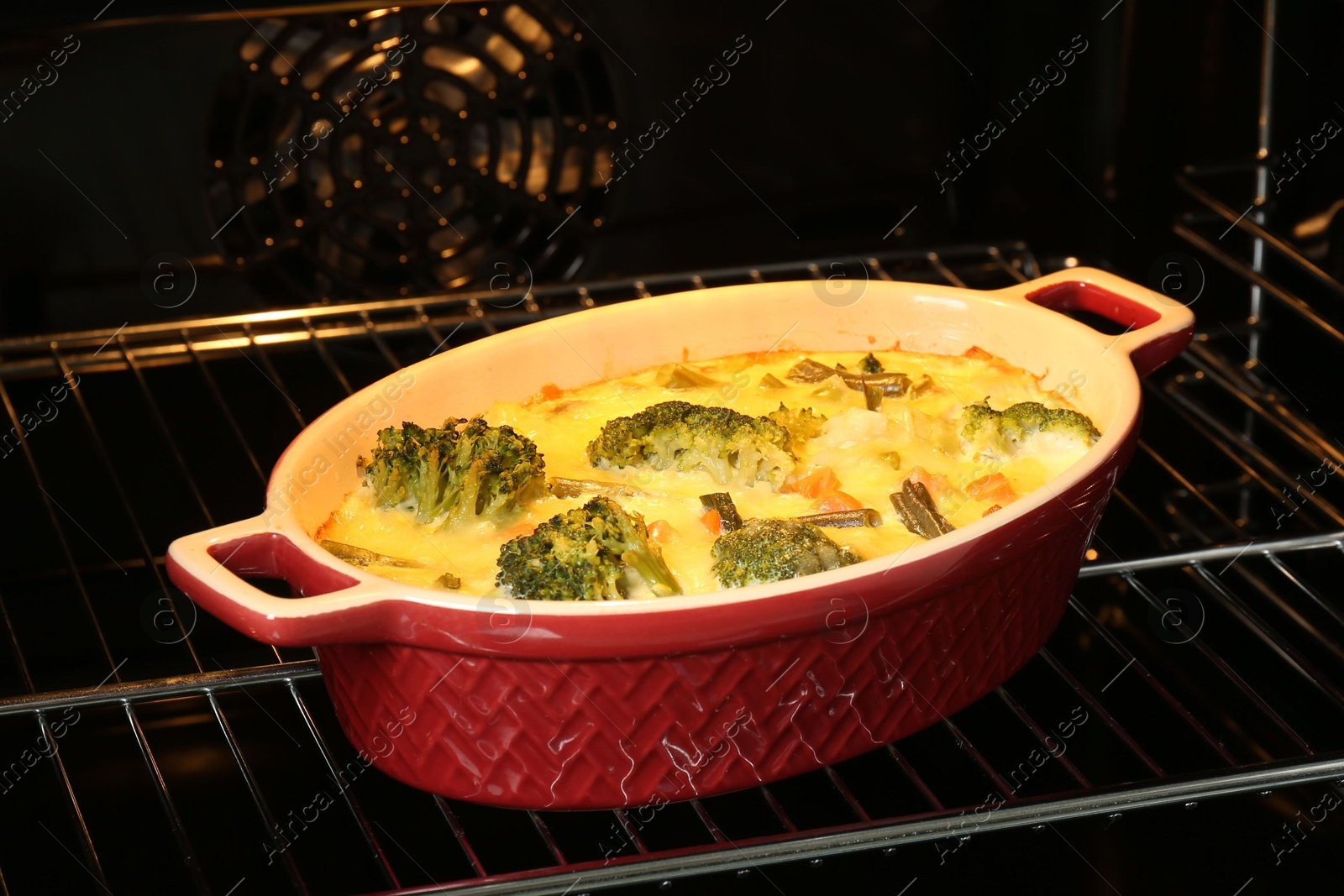 Photo of Delicious baked vegetable casserole in oven, closeup