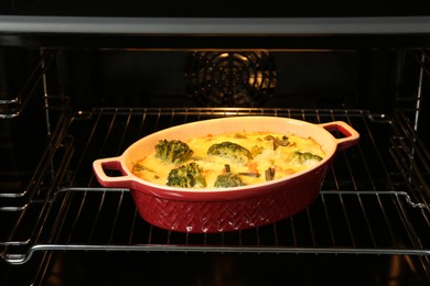 Photo of Baking dish with delicious vegetable casserole in oven