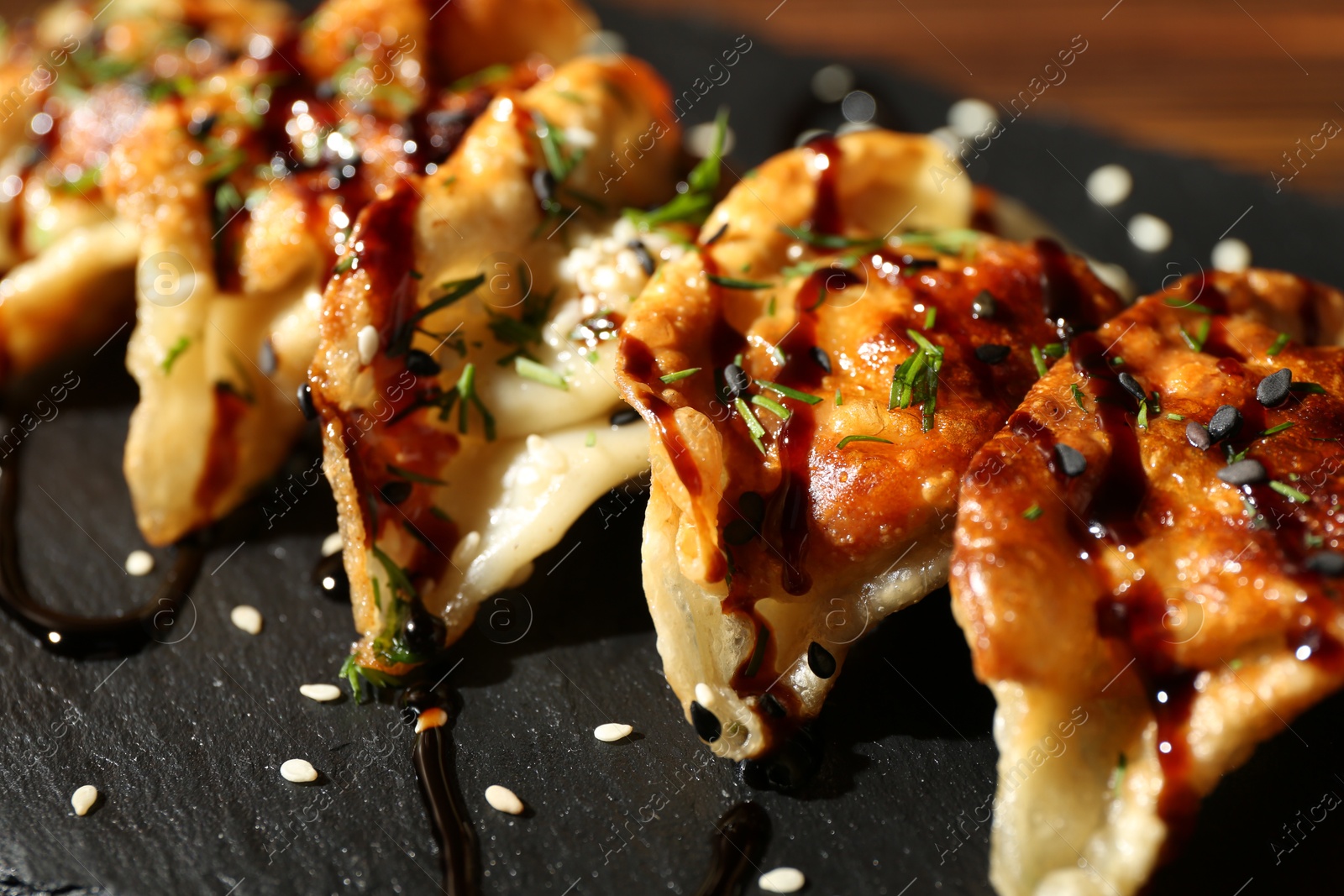 Photo of Tasty fried gyoza (dumplings) on table, closeup