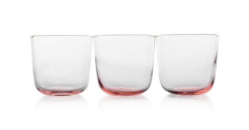 Photo of Three empty clean glasses isolated on white