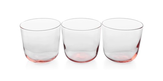 Photo of Three empty clean glasses isolated on white