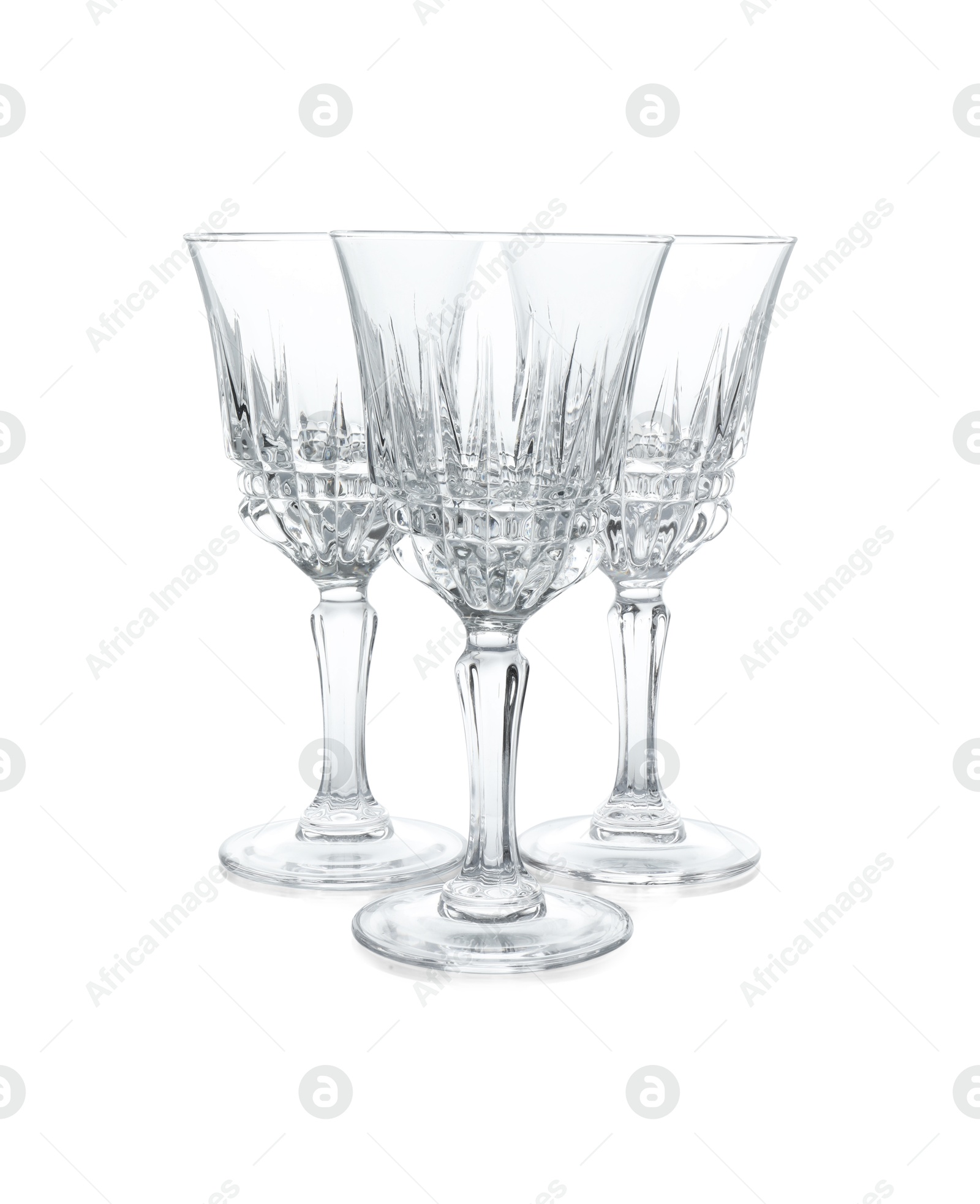 Photo of Three empty clean glasses isolated on white