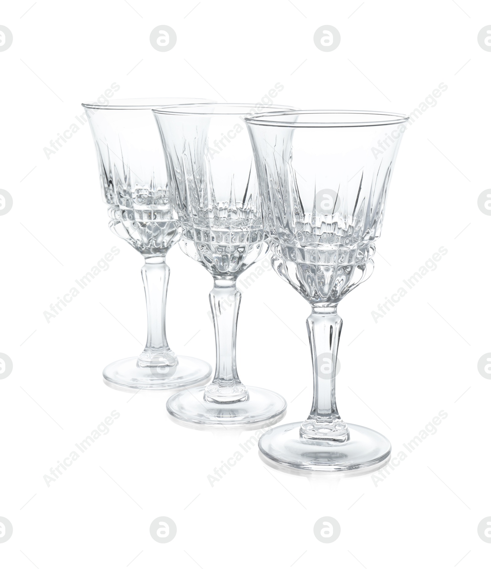 Photo of Three empty clean glasses isolated on white