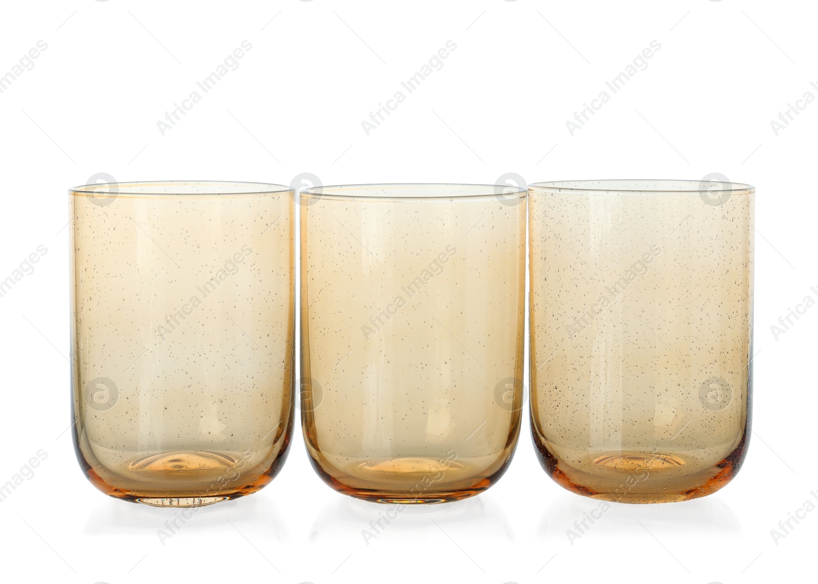 Photo of Three empty clean glasses isolated on white