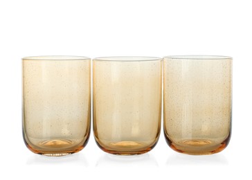 Photo of Three empty clean glasses isolated on white