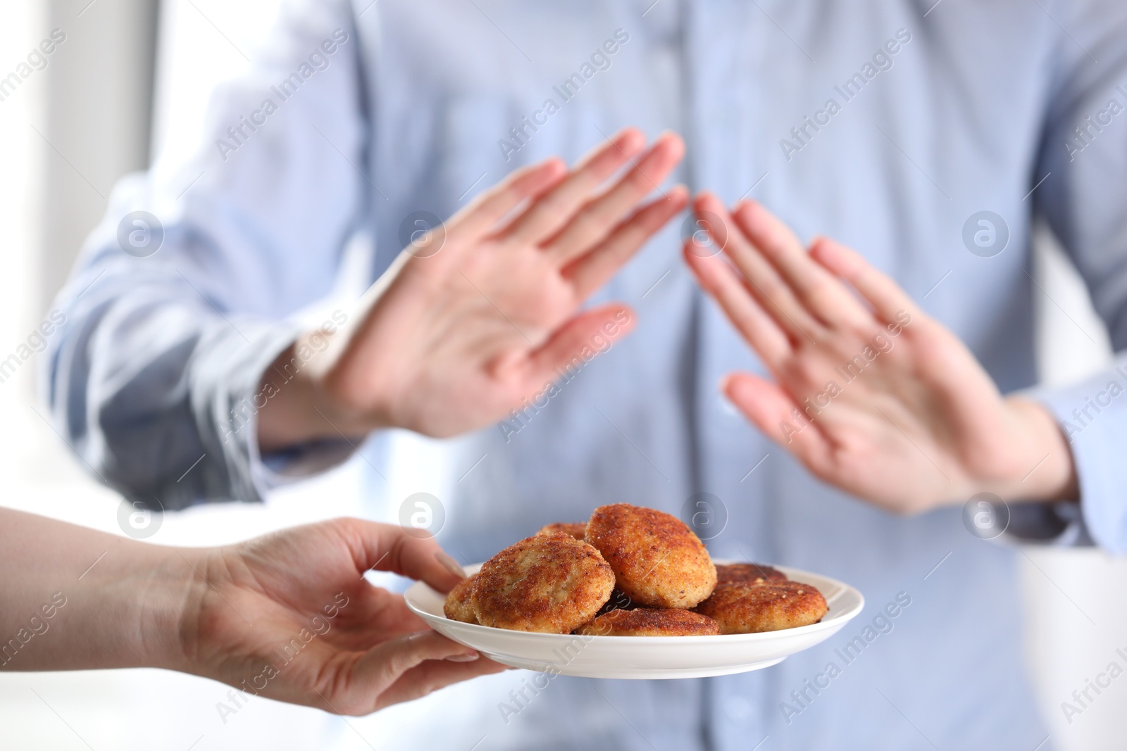 Photo of Woman refusing patties indoors, selective focus. Food allergy concept