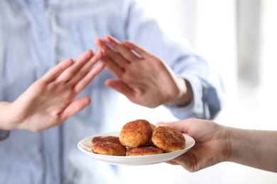 Photo of Woman refusing patties indoors, selective focus. Food allergy concept