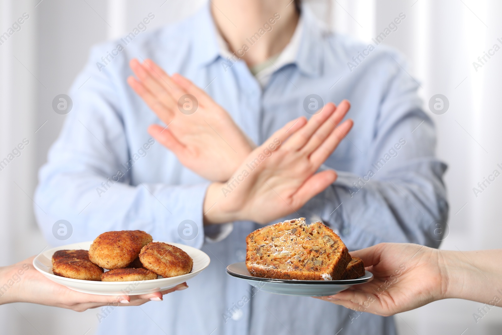 Photo of Woman refusing to eat products indoors, selective focus. Food allergy concept