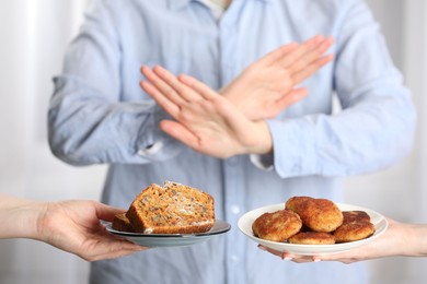 Photo of Woman refusing to eat products indoors, selective focus. Food allergy concept