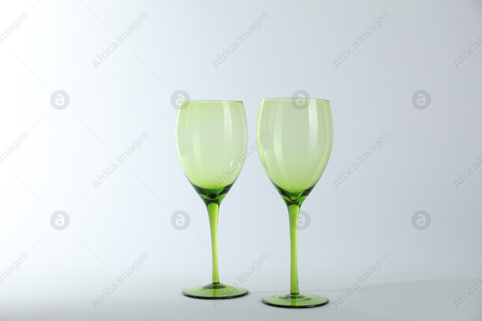 Photo of Two empty clean glasses on light background