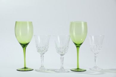 Photo of Many empty clean glasses on light background