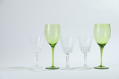 Photo of Many empty clean glasses on light background