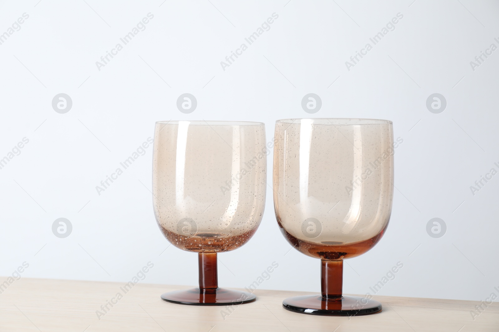 Photo of Two empty clean glasses on wooden table