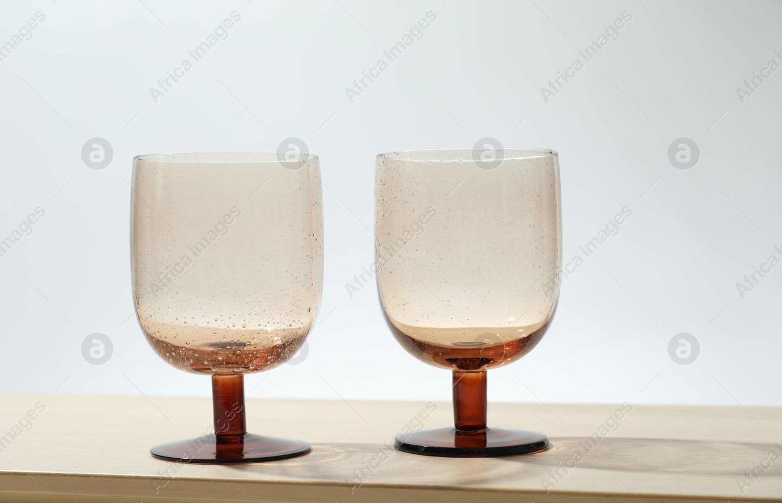 Photo of Two empty clean glasses on wooden table