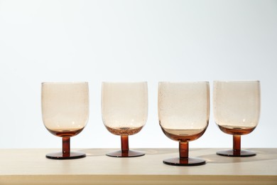 Photo of Many empty clean glasses on wooden table