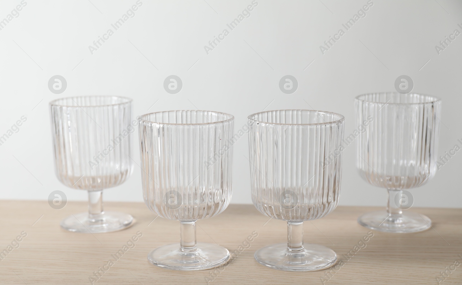 Photo of Many empty clean glasses on wooden table