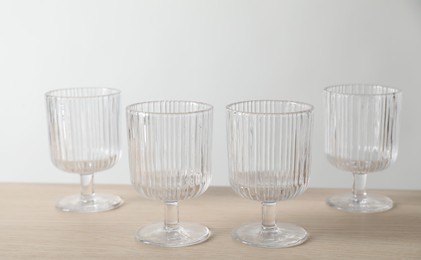 Photo of Many empty clean glasses on wooden table