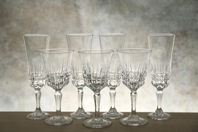 Photo of Many empty clean glasses on wooden table