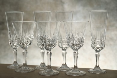 Photo of Many empty clean glasses on wooden table