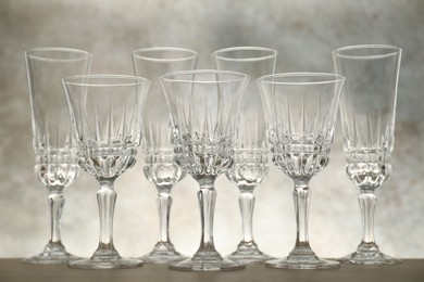 Photo of Many empty clean glasses on wooden table