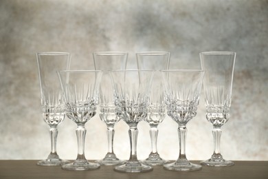 Photo of Many empty clean glasses on wooden table