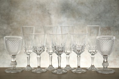 Photo of Many empty clean glasses on wooden table