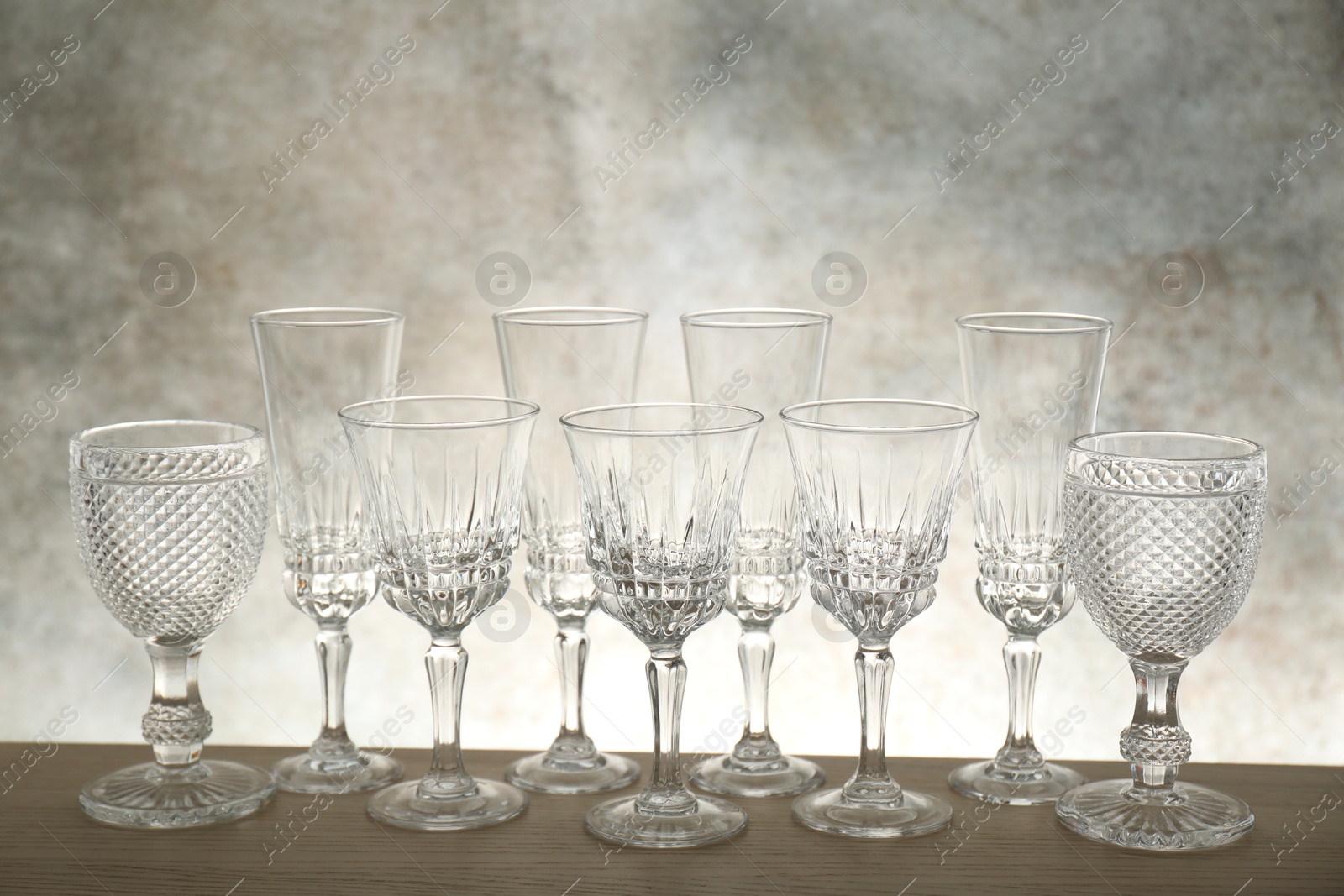 Photo of Many empty clean glasses on wooden table