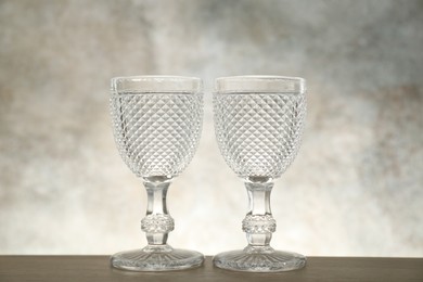 Photo of Two empty clean glasses on wooden table