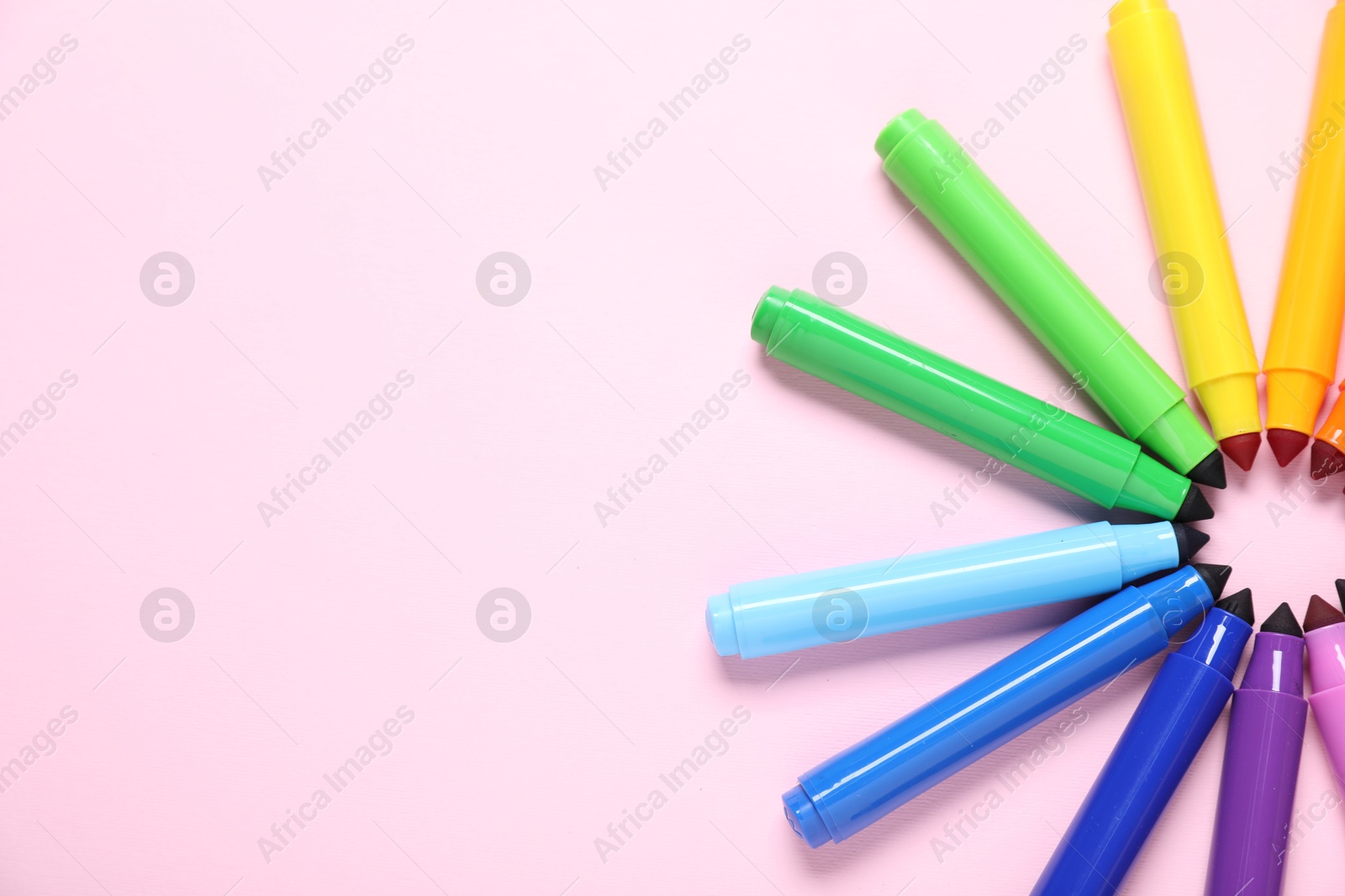 Photo of Many colorful markers on pink background, flat lay. Space for text