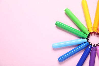 Photo of Many colorful markers on pink background, flat lay. Space for text