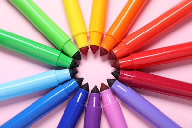 Photo of Many colorful markers on pink background, flat lay
