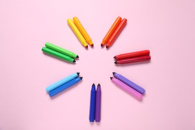 Photo of Many colorful markers on pink background, flat lay