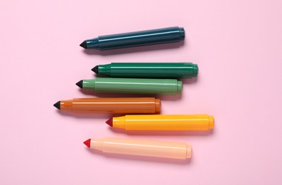 Photo of Many colorful markers on pink background, flat lay