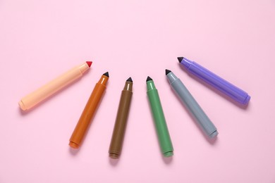Photo of Many colorful markers on pink background, flat lay