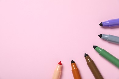 Photo of Many colorful markers on pink background, flat lay. Space for text