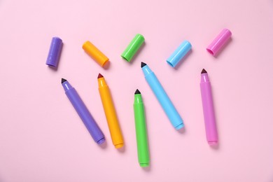 Photo of Many colorful markers on pink background, flat lay