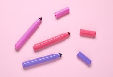 Photo of Many colorful markers on pink background, flat lay