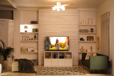 Image of Movie playing on TV set in room