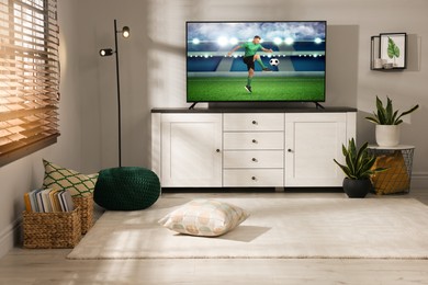 Image of Soccer game playing on TV set in room