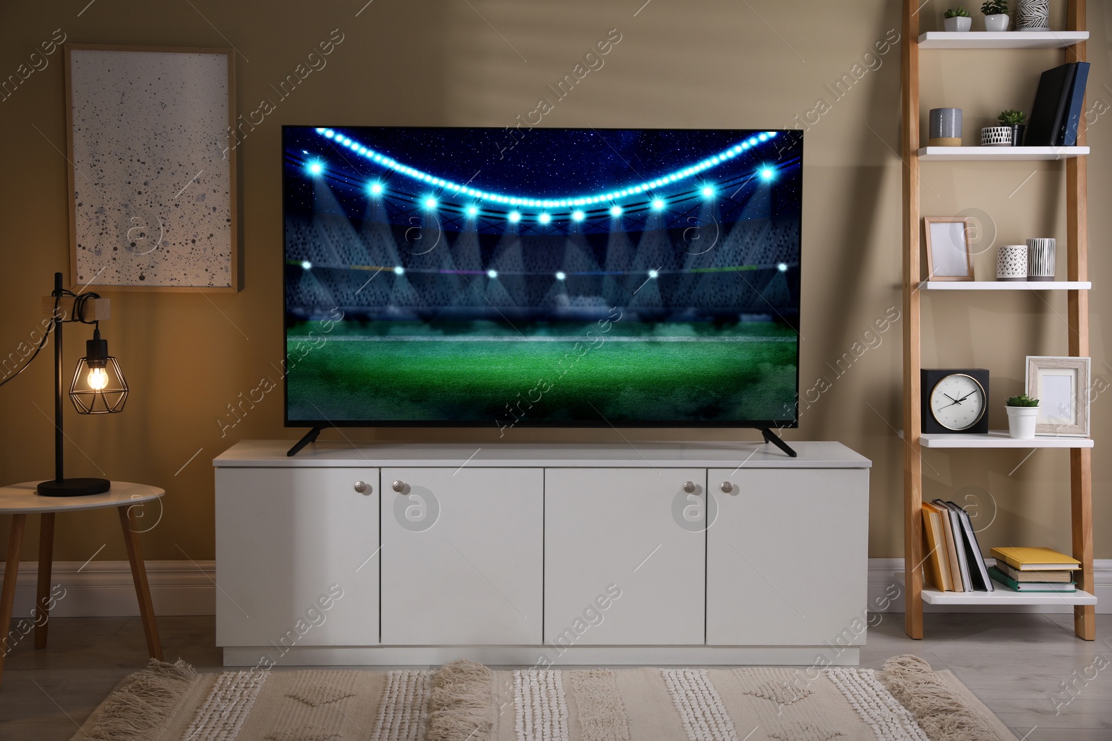 Image of Sport game playing on TV set in room