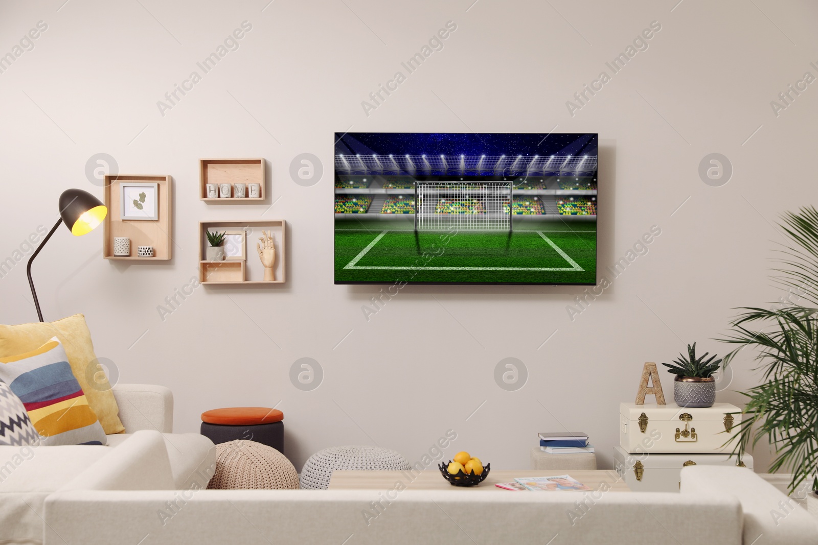 Image of Soccer game playing on TV set in room