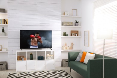 Image of Boxing fight playing on TV set in room