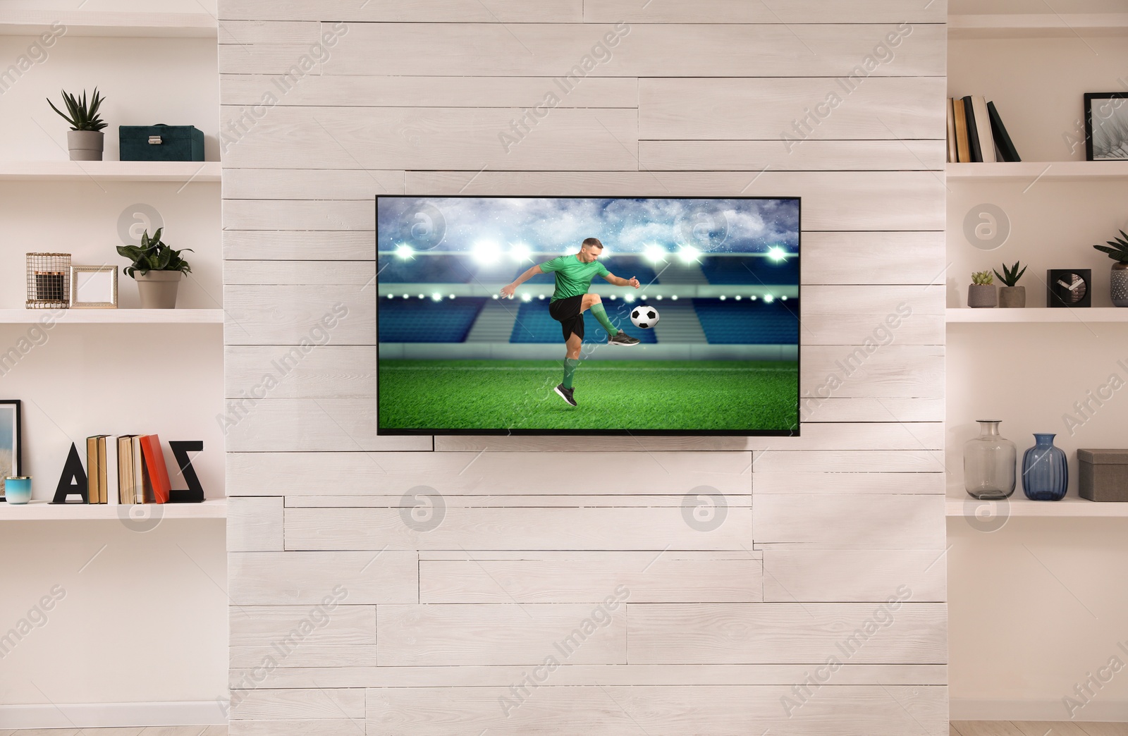 Image of Soccer game playing on TV set in room