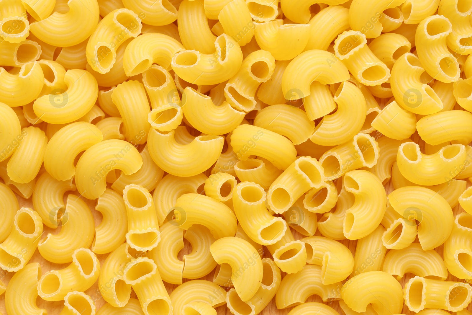 Photo of Raw horns pasta as background, top view