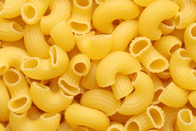 Photo of Raw horns pasta as background, top view