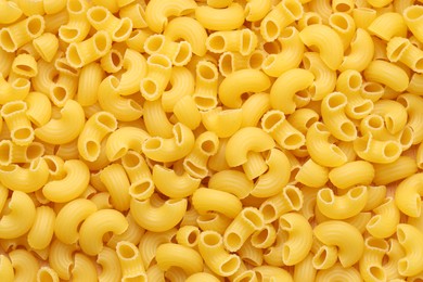 Photo of Raw horns pasta as background, top view