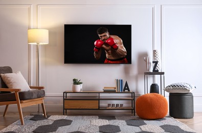 Image of Boxing fight playing on TV set in room