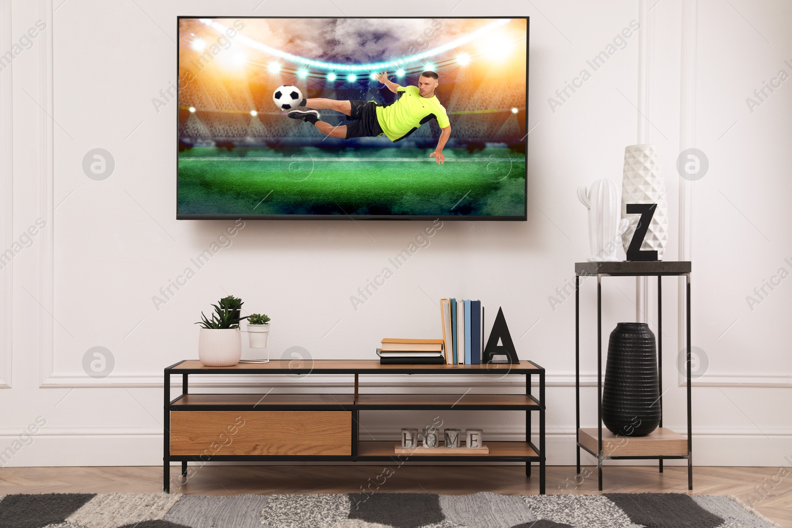 Image of Soccer game playing on TV set in room