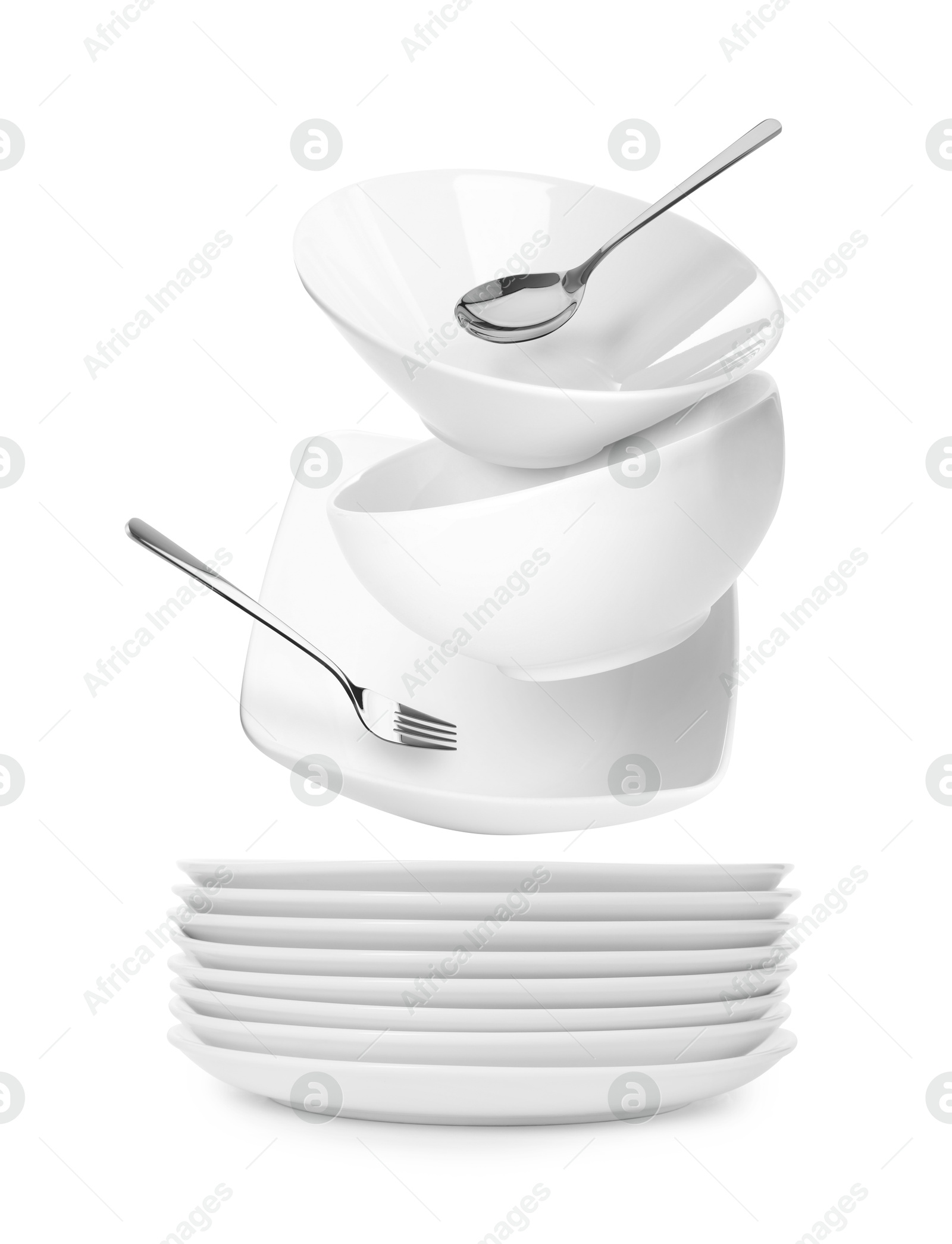 Image of Clean dishware and silverware flying over stacked plates on white background